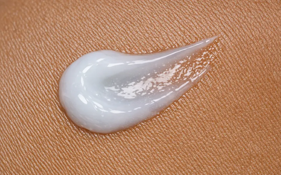 Close-up of a lightweight gel-cream moisturizer texture on medium-brown Indian skin